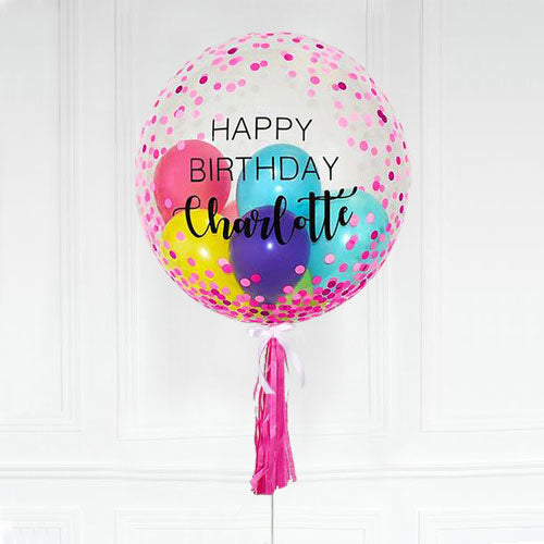Customised bubble balloon with a personalised message on a clear bubble balloon with pink confetti all over.