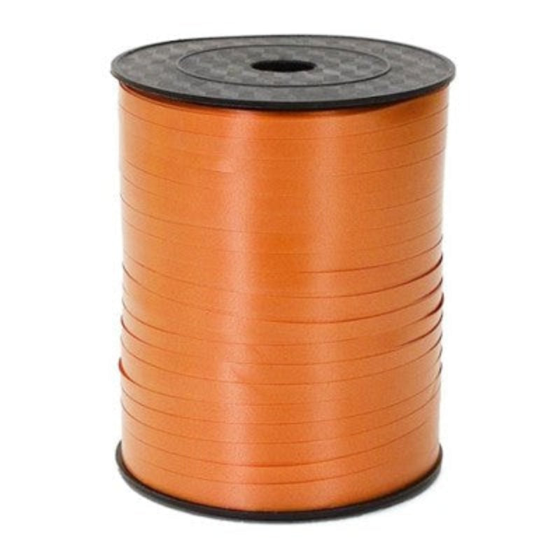 A roll of orange balloon ribbon on a spool.