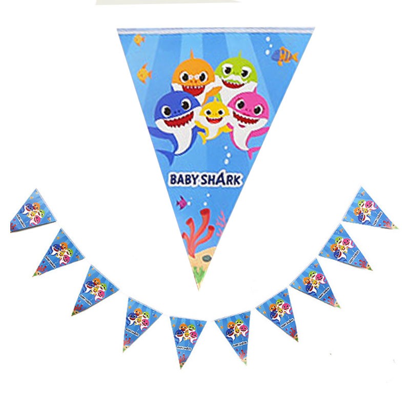 Hanging the Baby Shark Flag Banner at the backdrop of the cake table!
