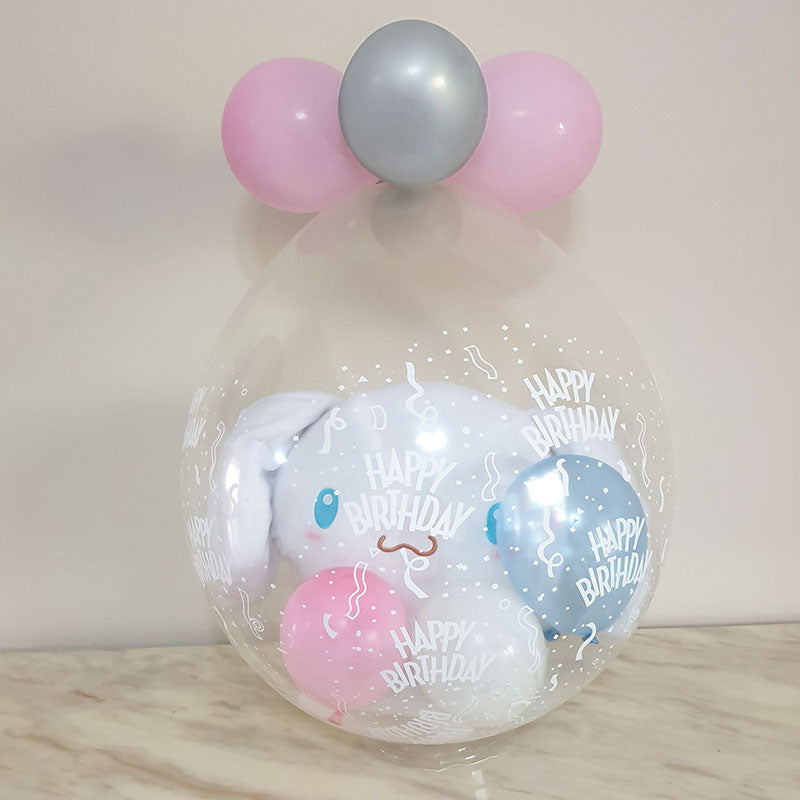 Cinnamon Roll wrapped nicely in a gift in a balloon for the birthday present.