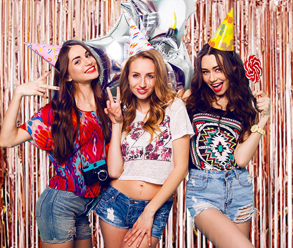 These rose gold foil streamer backdrop are marvellous. See how the girls are enjoying at the bachelorette party!