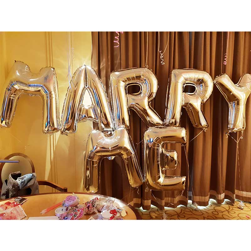 Setting up a jumbo "MARRY ME" sign for an extraordinary proposal. Say YES!