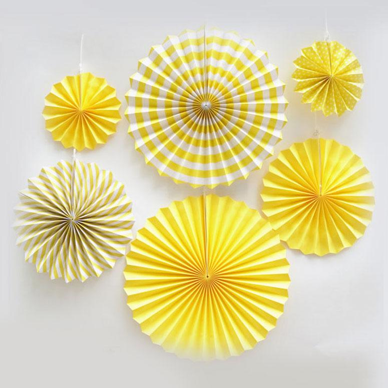 Paper fan decorations never fail to boost any backdrop decoration. They add to the colours and gives a special layered effect.  Yellow paper fans mixed with polkadots and swirls and stripes provides high contrasts of colours.