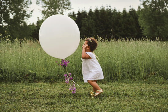 kid playing with a balloon