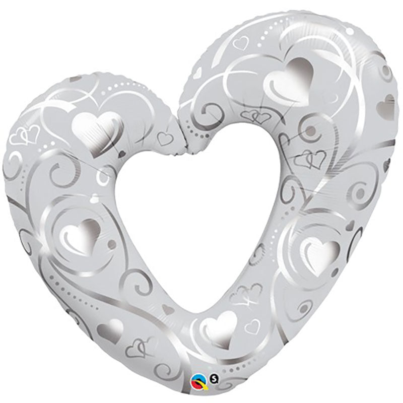 A 42 inch round pearl white balloon with a hearts and filigree pattern.