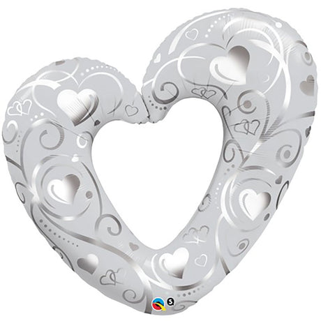A 42 inch round pearl white balloon with a hearts and filigree pattern.