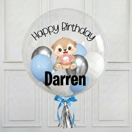 Clear bubble balloon with cartoon dog, 'Happy Birthday Darren' text, and blue and silver balloons on a white background.