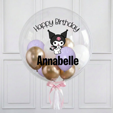 Clear balloon with gold, pink, and purple balloons featuring a cartoon character and 'Happy Birthday Annabelle' text on a white background.