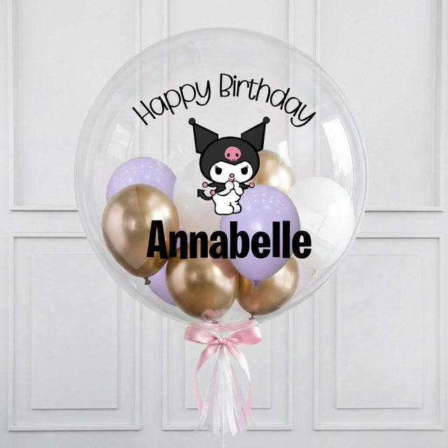 Clear balloon with gold, pink, and purple balloons featuring a cartoon character and 'Happy Birthday Annabelle' text on a white background.