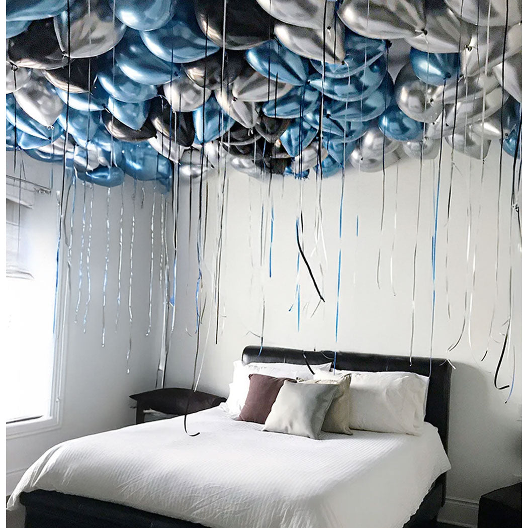 Chrome helium balloons filling up the ceiling of the room.