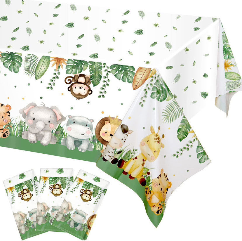 Jungle-themed tablecloth with animal illustrations and green leaves on a white background
