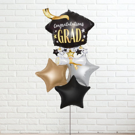 Graduation-themed balloon set with 'Congratulations GRAD' on a white brick background