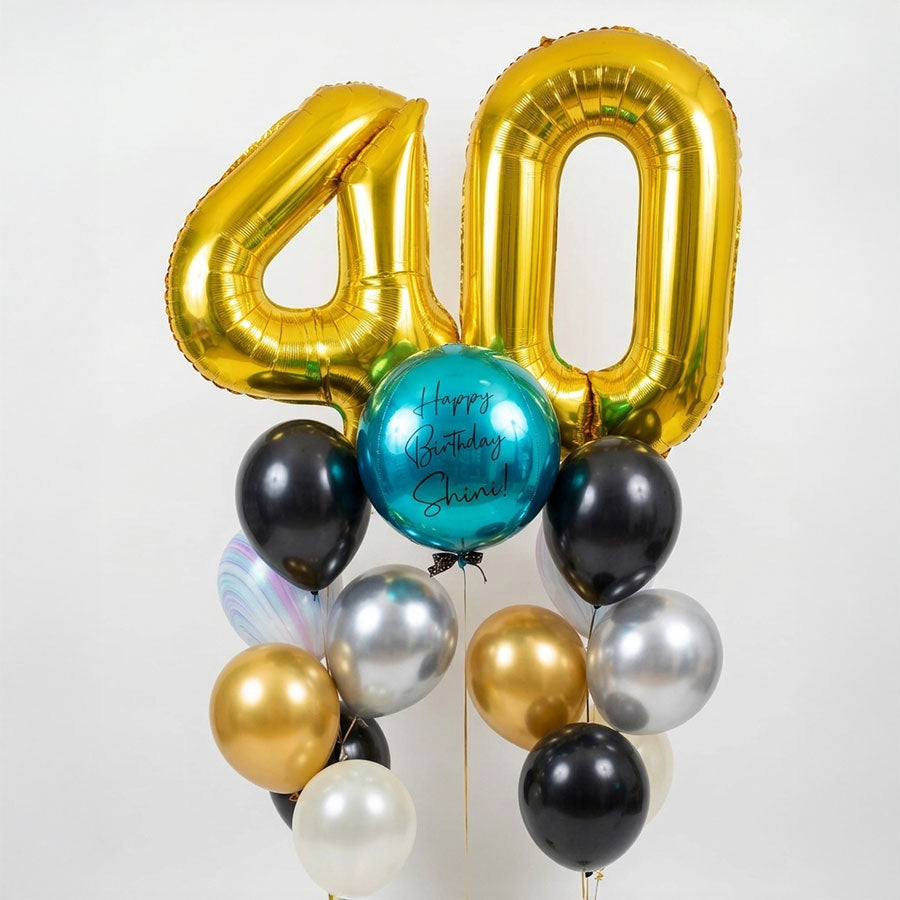 Gold number '40' balloon with other balloons on a white background