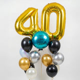 Gold number '40' balloon with other balloons on a white background