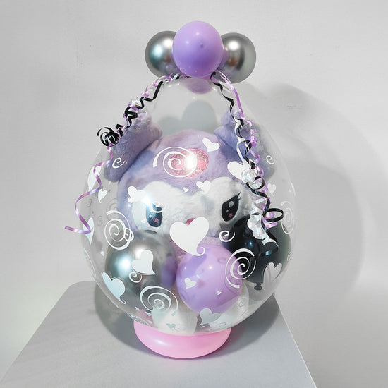 Kuromi lilac plush toy wrapped in a clear balloon.