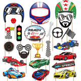 A set of colorful race car and racing-themed party cutout signs on sticks, including a helmet, racing goggles, checkered face mask, speed number, traffic light, trophy, steering wheel, flags, cars, and a speed sign, all arranged on a white background.