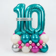 Turquoise number 10 balloon surrounded by smaller multicolored balloons on a white background