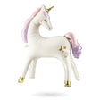 Unicorn-shaped plush toy with gold hooves and a pink mane on a white background