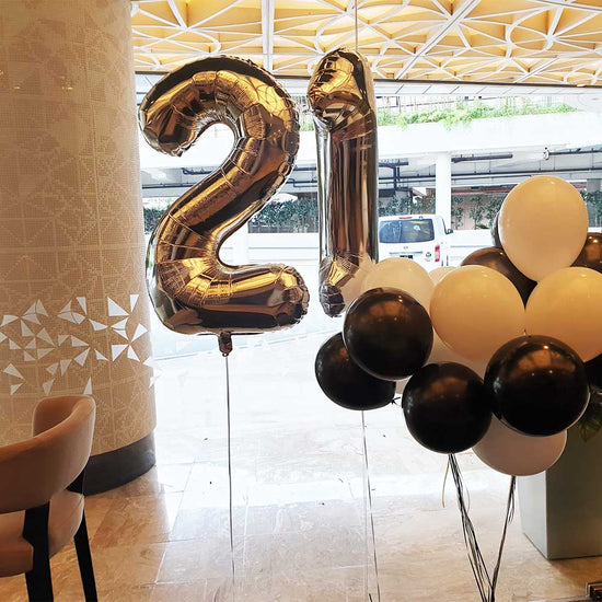 21st birthday balloon in silver, while and black.