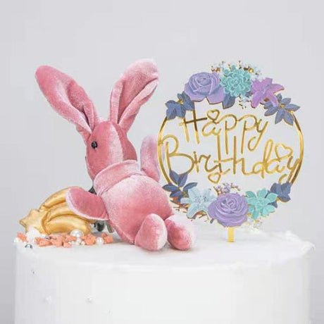 Gold reflective acrylic cake topper decorated with flowers for a simple yet classy birthday cake decoration. 