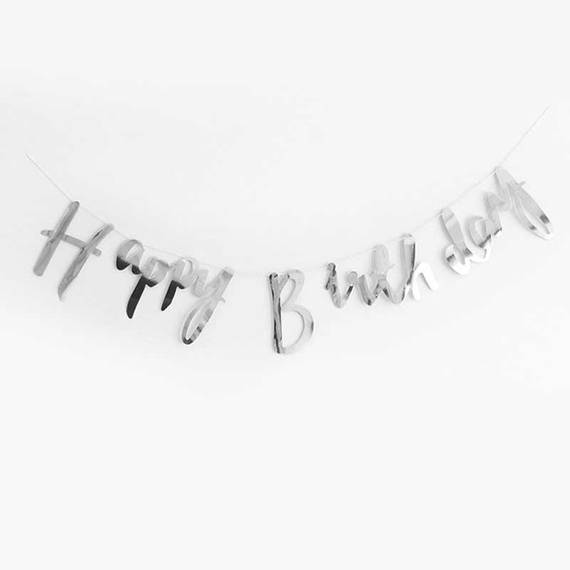 Silver foil letter bunting with a "Happy Birthday" message in cursive/