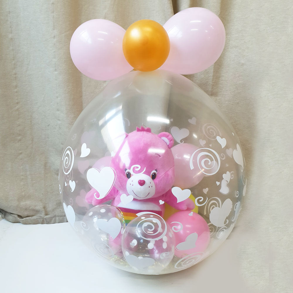 Care Bear soft toy wrapped in a balloon for an impressive gift.