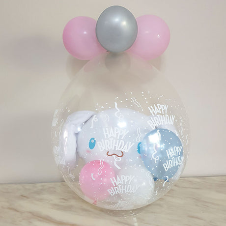 Cinnamon Roll wrapped nicely in a gift in a balloon for the birthday present.