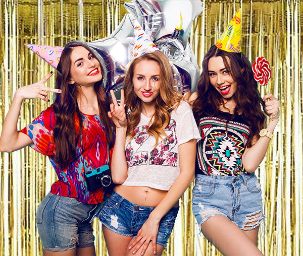 Birthday celebration for the girls with the golden foil streamer backdrop.