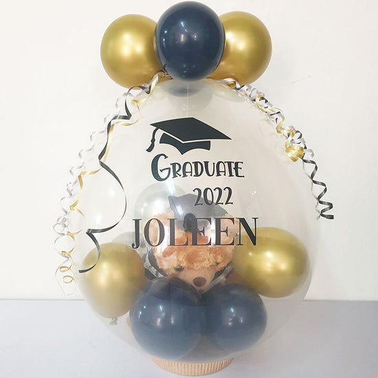Load image into Gallery viewer, Gift in a Balloon - Graduation Congratulations Bear wrapped in a clear latex balloon as a gift or as a decorative display. Great for Baby Shower, Birthday Surprise or Graduation Congratulations.
