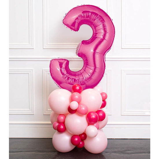 Fuchsia Number 3 Balloon in a pink and hot pink balloon colomn.