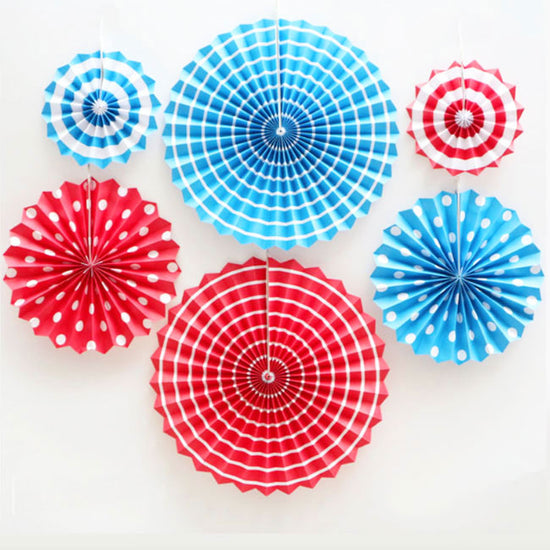 Blue and Red paper fans mixed with polkadots and swirls and stripes provides high contrasts of colours.