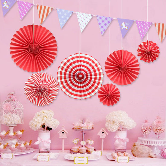 Bright red styes paper fan set for this lovely dessert table set up.