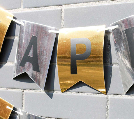 Shimmering and shiny foil fishtail shaped bunting with black HAPPY BIRTHDAY words.