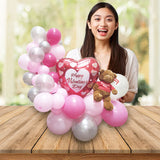 Girlfriend so happy to receive a Valentine's Day balloon bouquet with a cute Gund Bear with a "I Love You" message on the shirt.