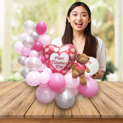 Girlfriend so happy to receive a Valentine's Day balloon bouquet with a cute Gund Bear with a "I Love You" message on the shirt.